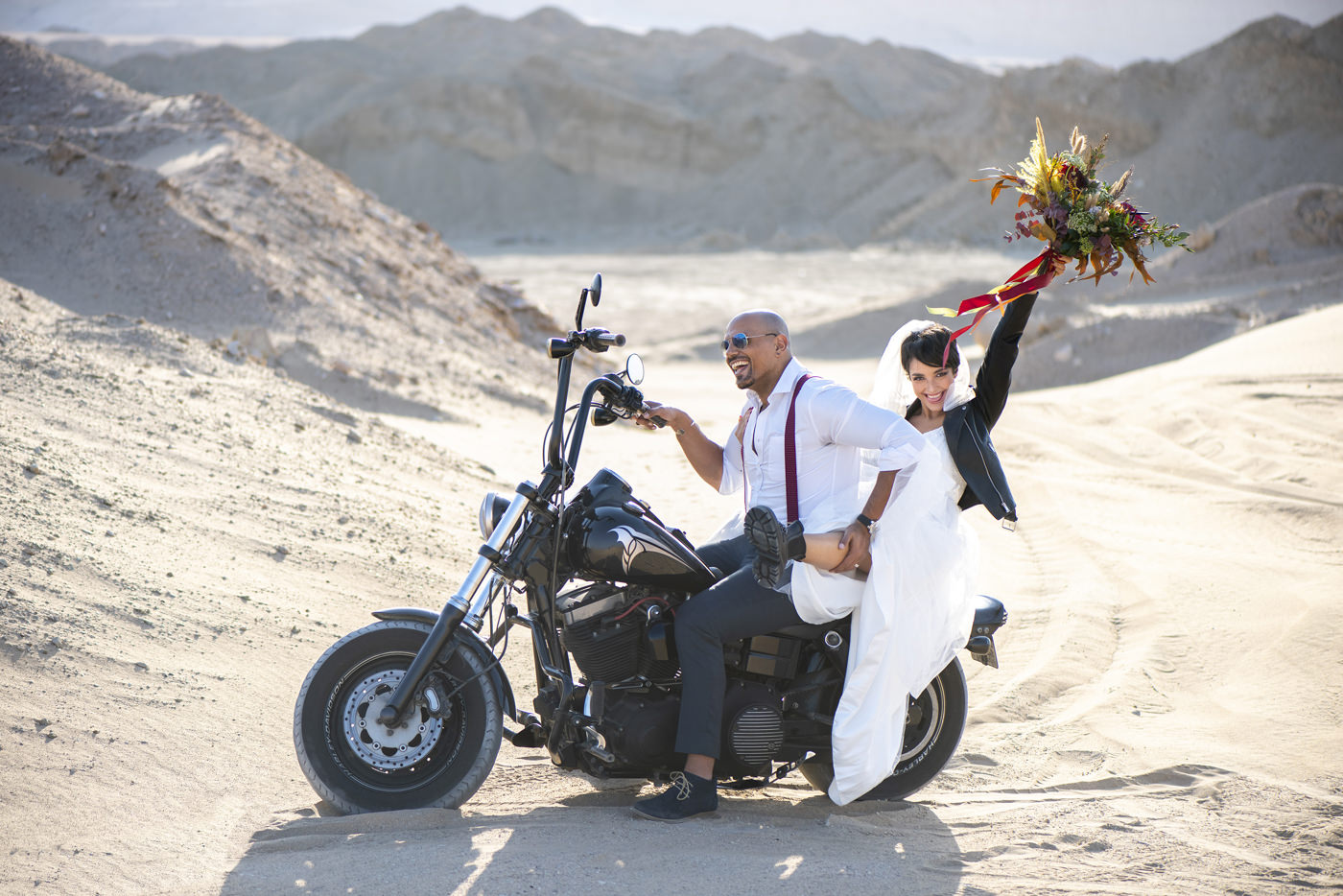 Happy Couple in Wedding Outfit on a Motorbike
