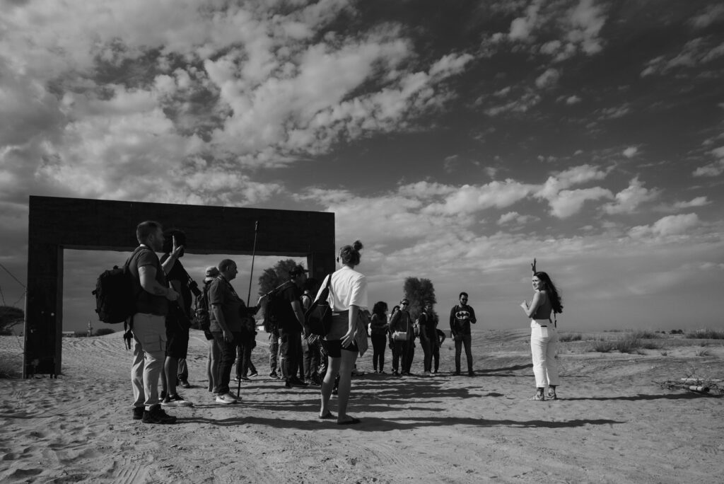 Black and white image of a photography workshop in the desert